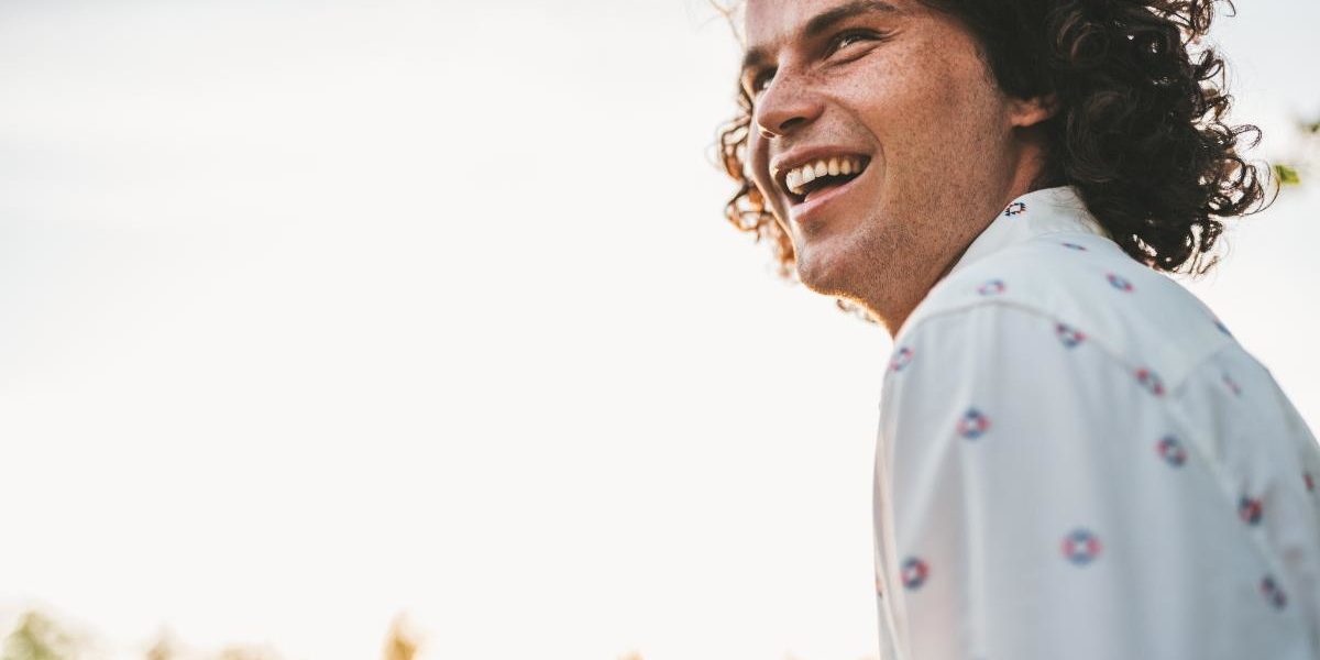 man smiling as he works through the stages of alcoholism recovery