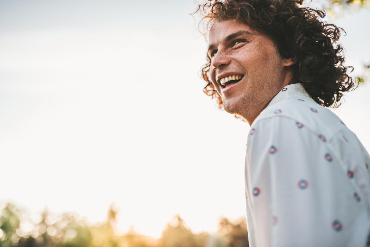 man smiling as he works through the stages of alcoholism recovery