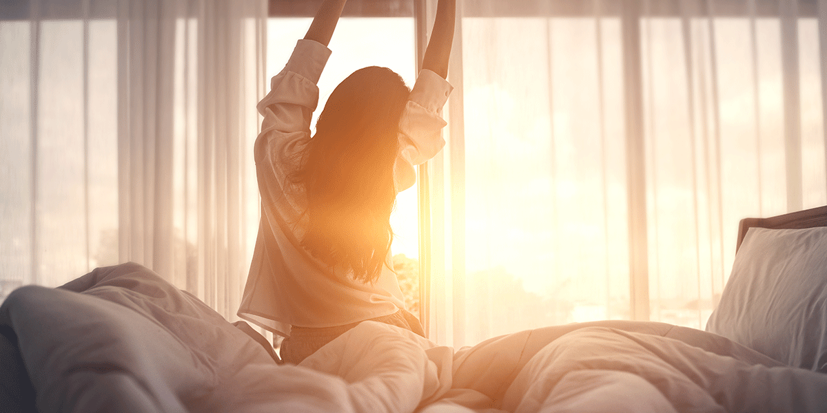 Finding-a-Luxury-Alcohol-Rehab-Center- woman waking up and stretching in luxury alcohol rehab center